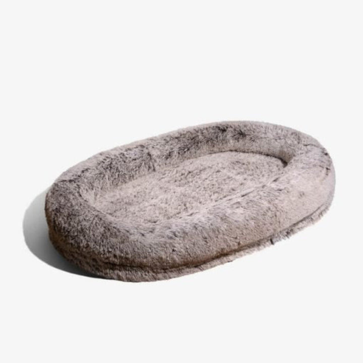 Giant gray faux fur calming pet and human bed providing ultimate anti-anxiety comfort & relaxation. Lounging for all.