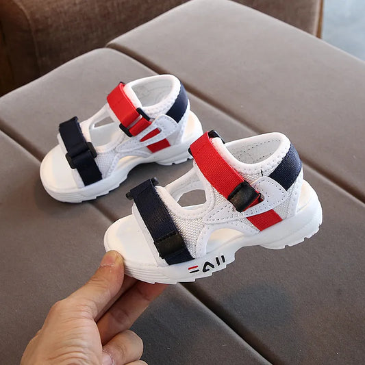 Pair of blue children's slip-on sport sandals with soft sole and hook-and-loop closure, perfect for beach.