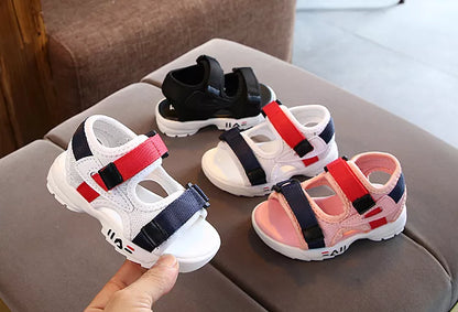 New pair of black children's summer sandals, soft sole beach shoes with hook-and-loop fastening.