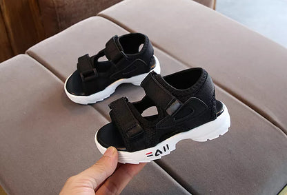 Focus on the hook-and-loop closure of a child's sandal, ensuring a snug fit for youth footwear.