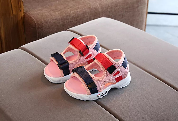 Unisex black children's sandals for beach, soft sole and anti-slip surface for safe play.