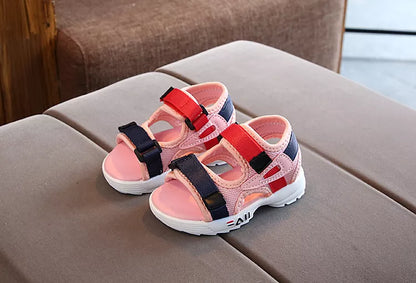 Unisex black children's sandals for beach, soft sole and anti-slip surface for safe play.