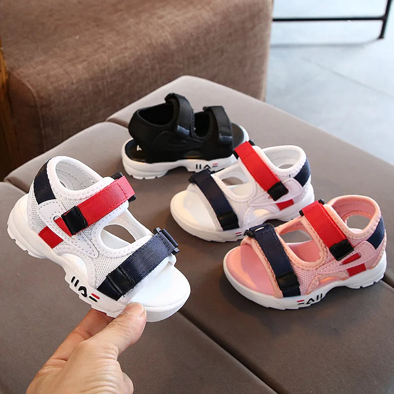 Close-up of the soft sole of red children's sport sandals, highlighting anti-slip texture for toddlers.