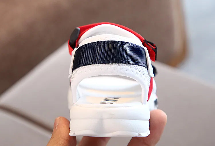 Red slip-on sport sandals for kids, drying in the sun, quick-drying summer footwear.