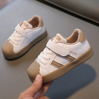 Comfortable white children's sneakers with anti-slip design and easy-on straps for active play and durability.