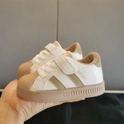 Top-down view of white children's fashion-forward anti-slip sneakers, designed for comfort and active, everyday wear.