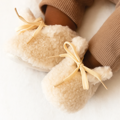 Pair of cozy non-slip infant booties for new walkers, plush baby shoes with secure fit.