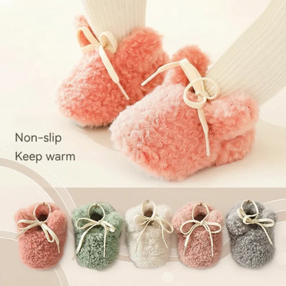 Infant wearing plush non-slip booties, comfortable baby shoes for new walkers.