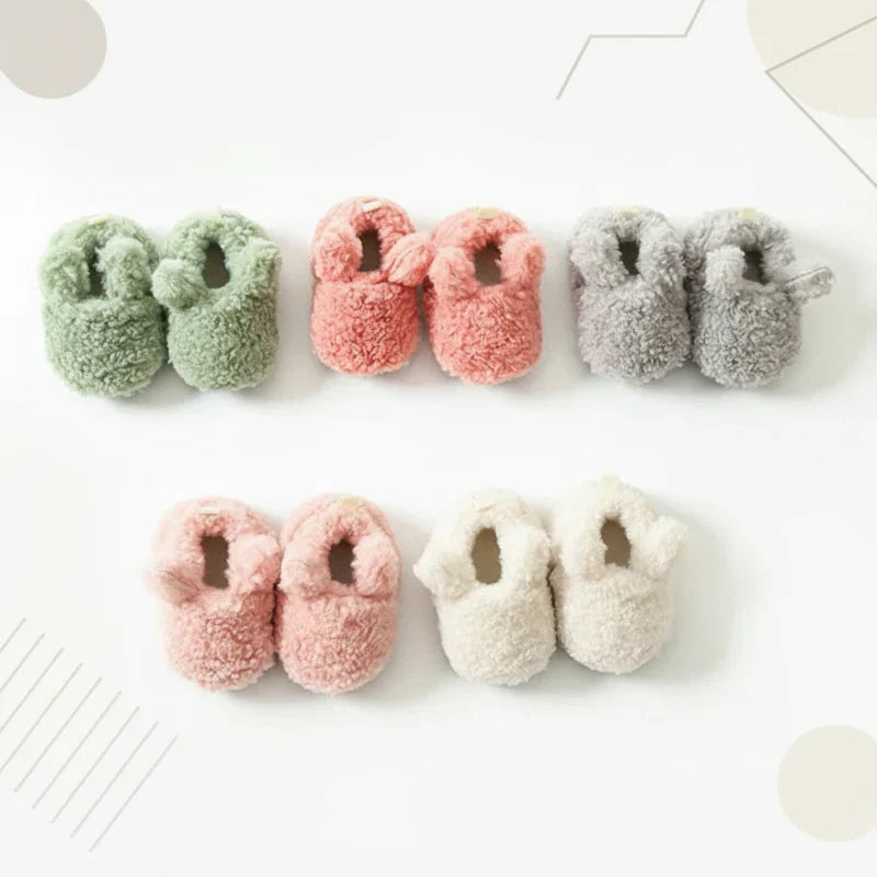 Side view of warm baby booties, non-slip winter shoes for infants, comfortable new walker footwear.