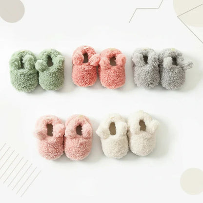 Side view of warm baby booties, non-slip winter shoes for infants, comfortable new walker footwear.