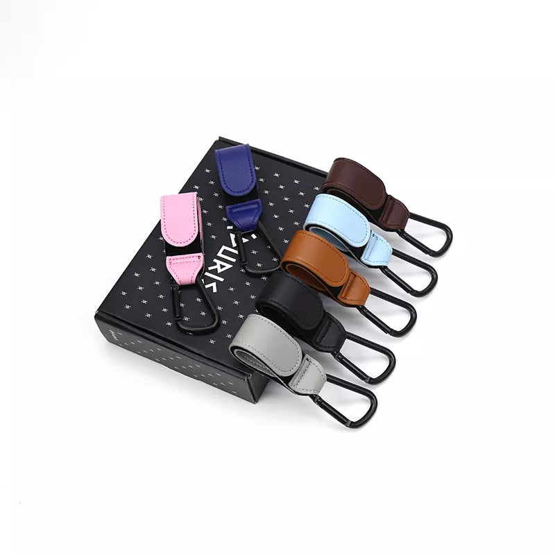 Close-up of a brown PU leather stroller hook with metal clasp for cart organizing