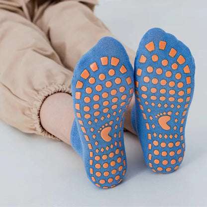 Pair of unisex grey anti-slip trampoline sports socks made from cotton with grip.