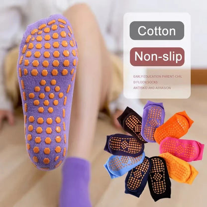 Stack of colorful cotton anti-slip socks for trampoline sports and playtime.
