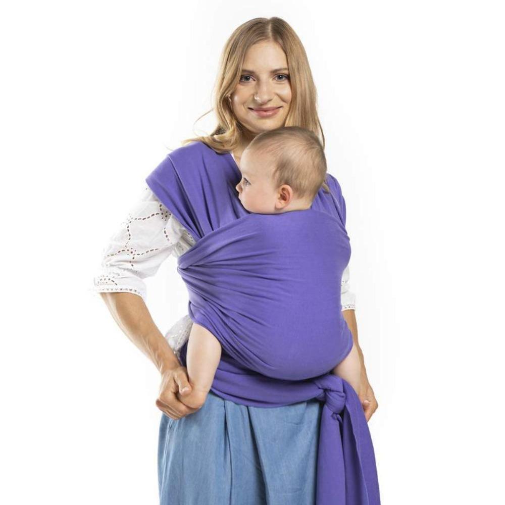 Mom easily wrapping an infant sling around herself, demonstrating the hassle-free baby carrier.