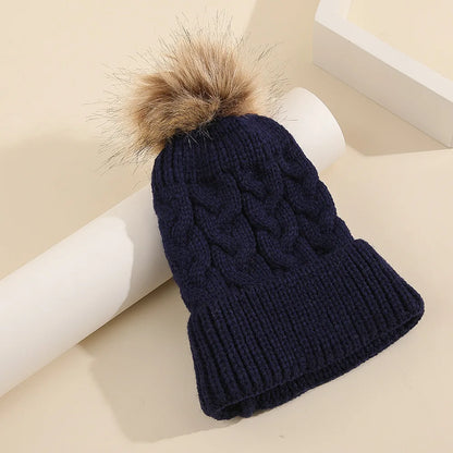 Detail shot of the knit texture and pom pom on a personalized girls' beanie hat