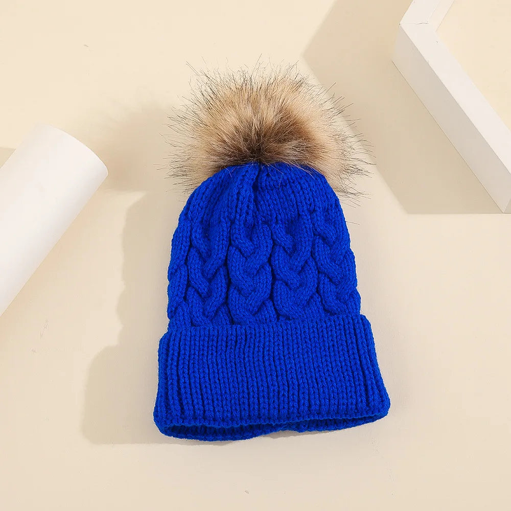 Display of various personalized knit pom pom beanies, custom winter hats for children