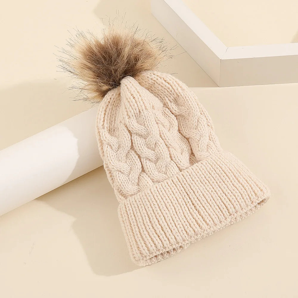 Child modeling a personalized knit pom pom beanie, excellent winter accessory for kids