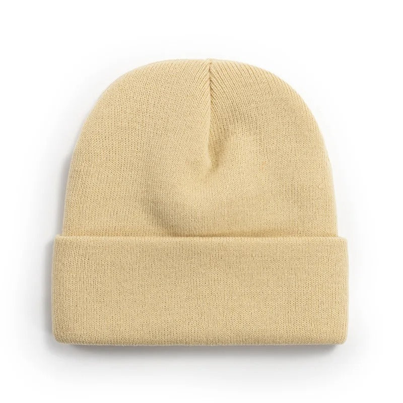 Stack of folded personalized beanies with various initials, 'L', 'M', 'N' visible, gift idea