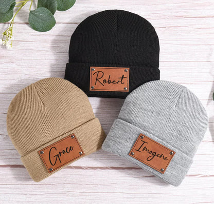 Close-up of vegan leather initial patch 'D' on a soft, custom acrylic beanie hat