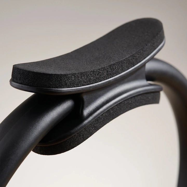 Durable Pilates resistance ring with padded handles, ideal for leg, arm, and core toning exercises. Perfect for home fitness.