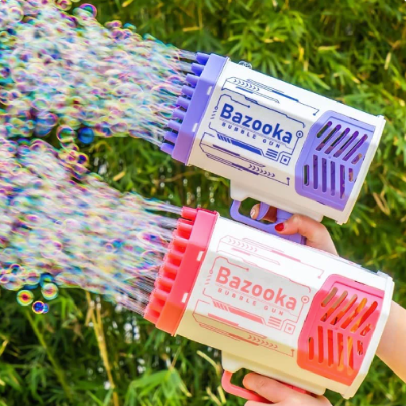 Pink and purple kids' automatic bubble blaster machine creating a cloud of bubbles; children's entertainment.