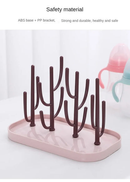 Compact pink baby bottle drying rack, empty, ready for next use, a simple yet vital baby product.