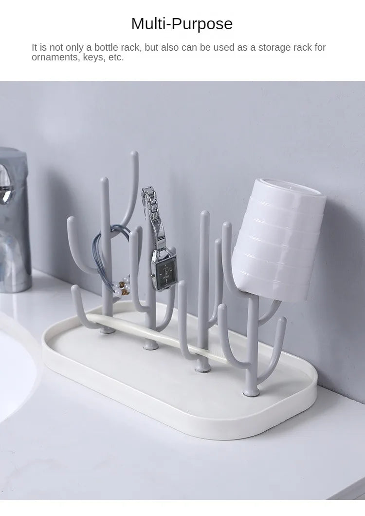 Side view of a pink baby bottle drying rack, demonstrating its stable and non-slip base.