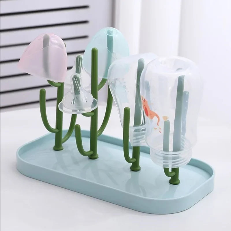 Blue baby bottle drying rack for convenient feeding organizer, on a clean kitchen countertop.