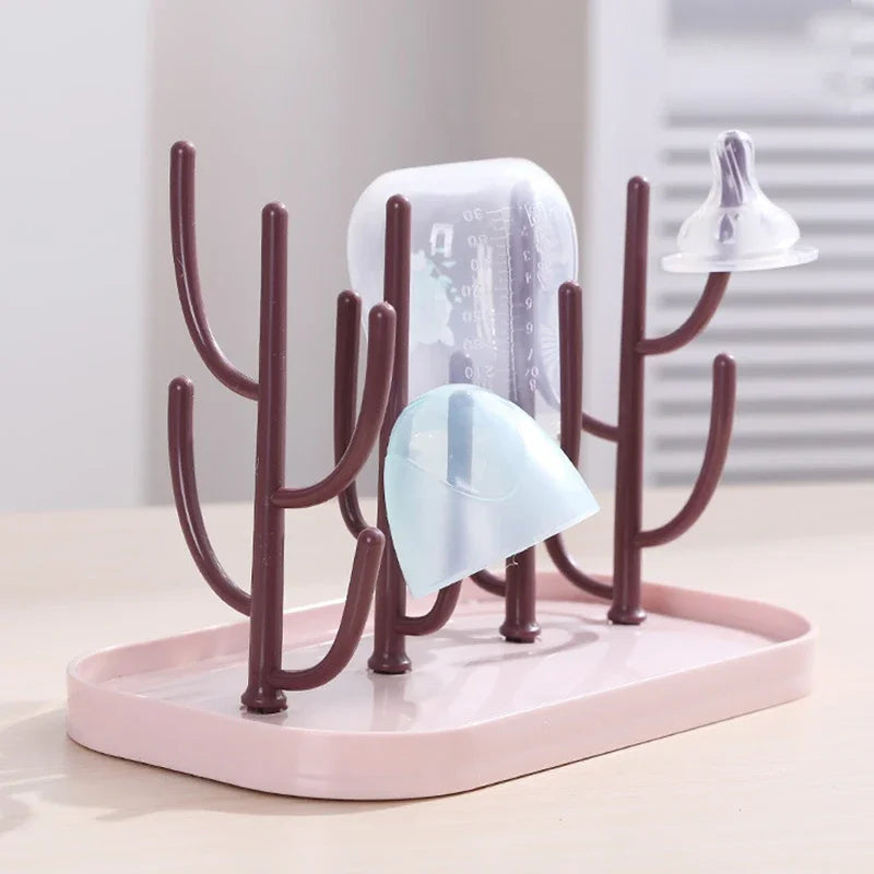 Compact baby bottle dryer in pink, showing detachable base for easy cleaning, a nursery essential.