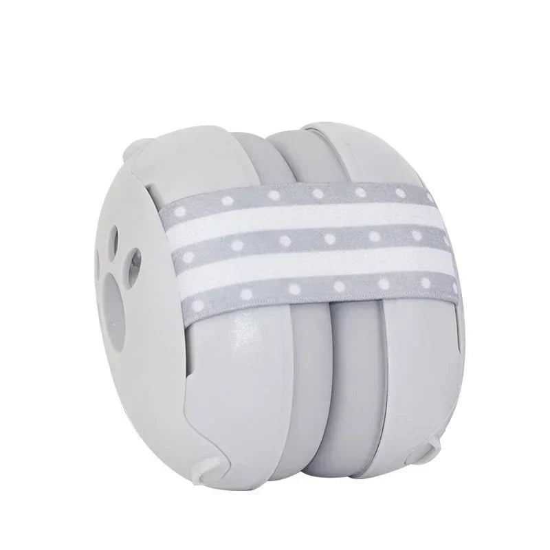 A child giggling while wearing blue noise-canceling earmuffs, comfortable and secure hearing protection.