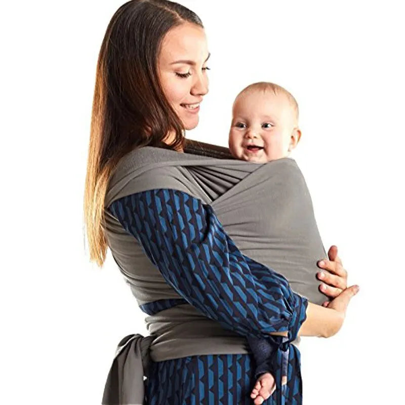 Comfortable baby carrier sling in pink, black, and gray, offering hands-free convenience for newborns.