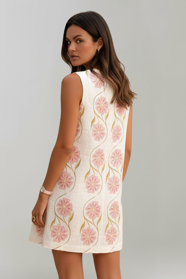 Stylish women's pink floral mini dress. Sleeveless A-line summer clothing, perfect for casual or vacation.