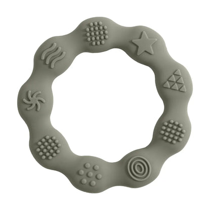 Baby playing with a star-shaped green silicone teether, BPA-free, for soothing relief