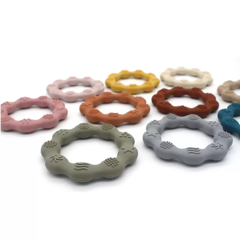 Baby chewing on a yellow silicone teether, BPA-free, promoting healthy oral development and relief