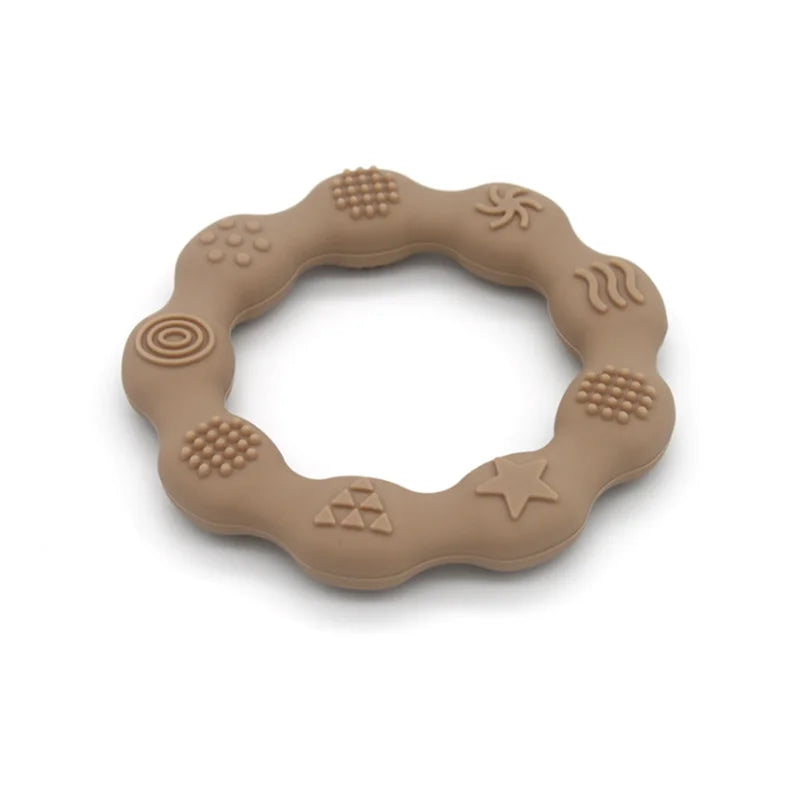 Close-up of a baby's gums against a soft blue silicone teether, BPA-free, for instant relief