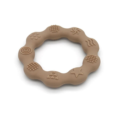 Close-up of a baby's gums against a soft blue silicone teether, BPA-free, for instant relief