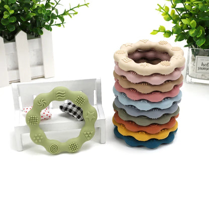 Green flower-shaped silicone baby teether, a safe infant molar toy for soothing relief