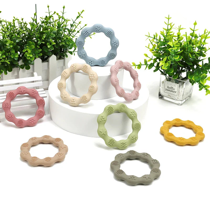 Yellow silicone teether with textured surfaces, BPA-free, ideal for baby oral development