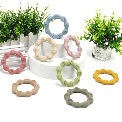 Yellow silicone teether with textured surfaces, BPA-free, ideal for baby oral development