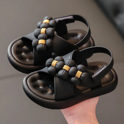 White girls' platform sandals decorated with flower accents, cute and stylish children's footwear.