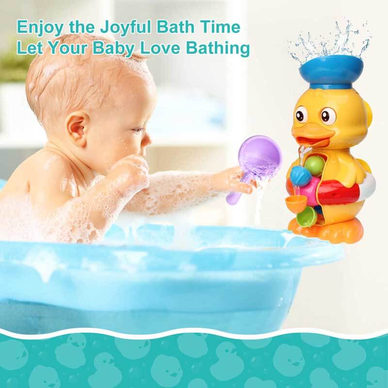 Toddler holding a pink interactive duck bath toy, smiling during water play