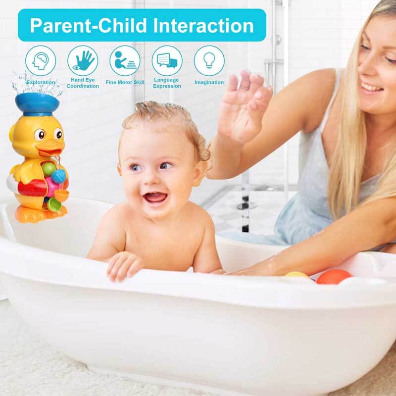 Baby reaching for a pink interactive duck bath toy during bathtime fun