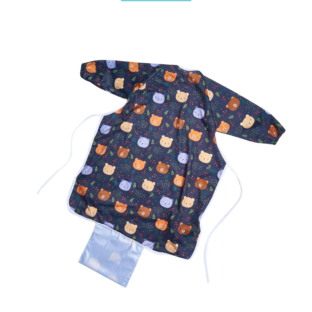 Baby wearing a grey long sleeve waterproof feeding bib, enjoying a mess-free mealtime
