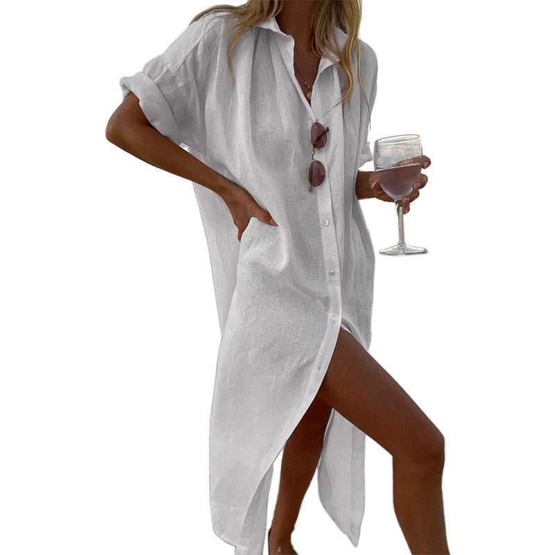 Stylish white oversized button-down beach shirt dress, a comfortable roll-sleeve cover-up for women's summer fashion.