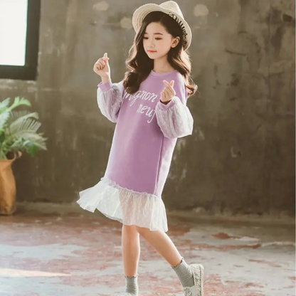 Close-up of pink polka dot and lace fabric on a girl's knee-length dress, cotton material, youth