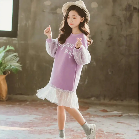 Close-up of pink polka dot and lace fabric on a girl's knee-length dress, cotton material, youth