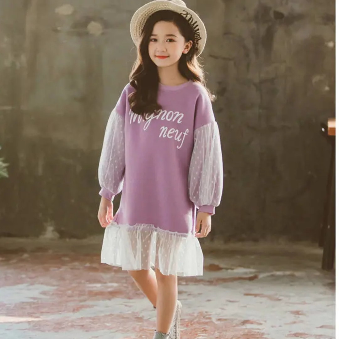 Toddler girl in a stylish pink polka dot lace knee-length dress, comfortable cotton for play