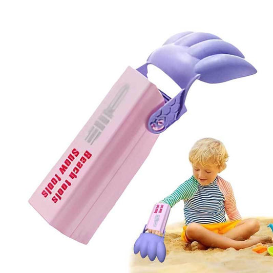 Pink sand digger toy for kids on a sunny beach, promoting outdoor play and motor skills.