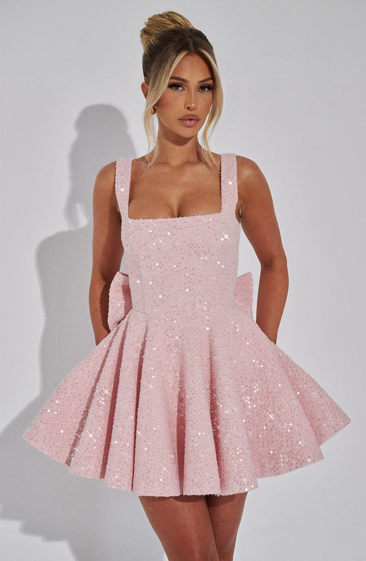 Elegant pink sequin homecoming dress, formal skater style with bow detail for dancing.