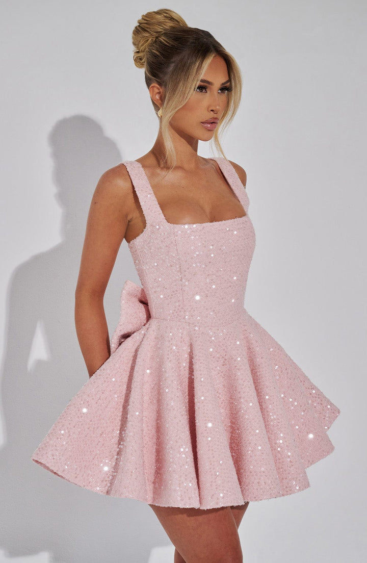 Women's formal pink sequin skater dress with bow, great for homecoming & dance events.